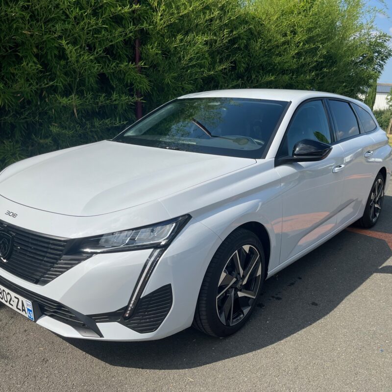 Voiture blanche sur un parking.